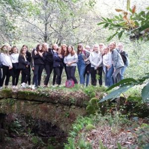 group of students by an overgrown bridge