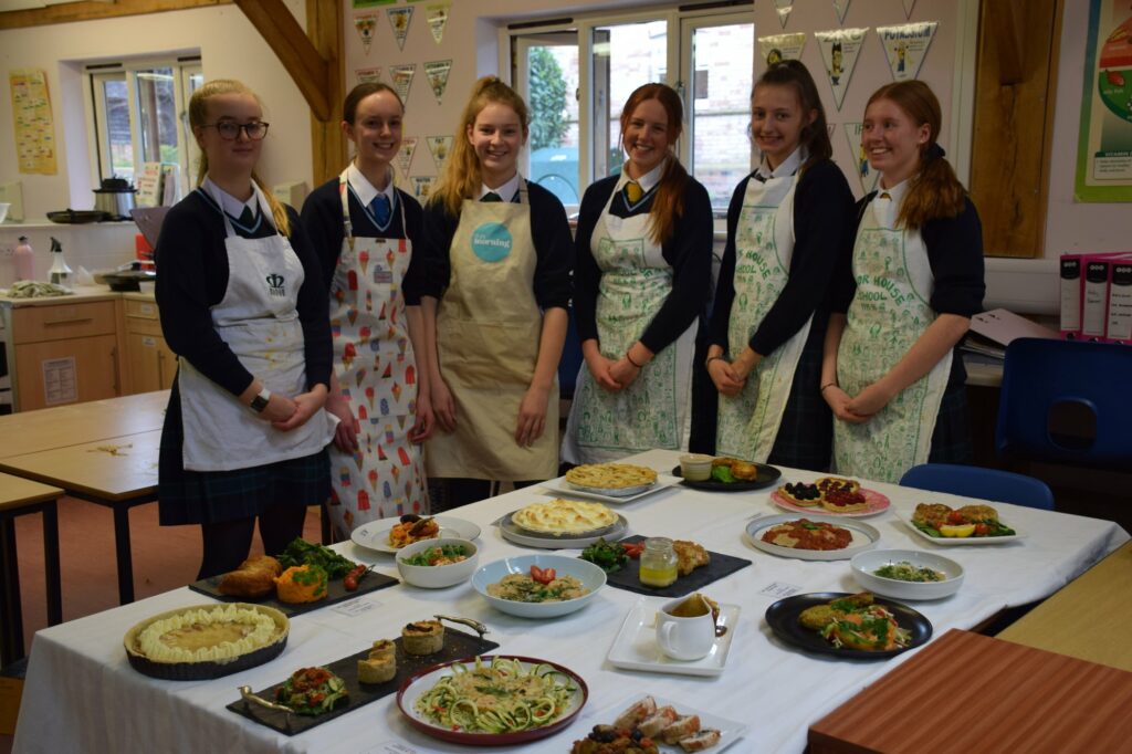 students in front of a table of food