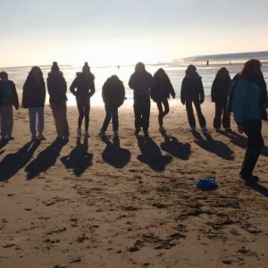 students walking along the beach