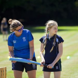girl and lady holding a bat