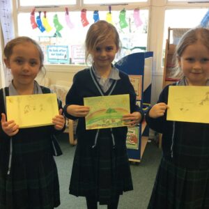 year 1 students holding cards