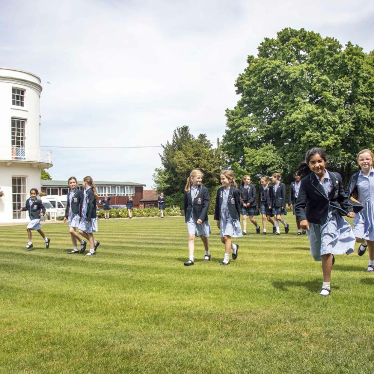 students walking across lawn