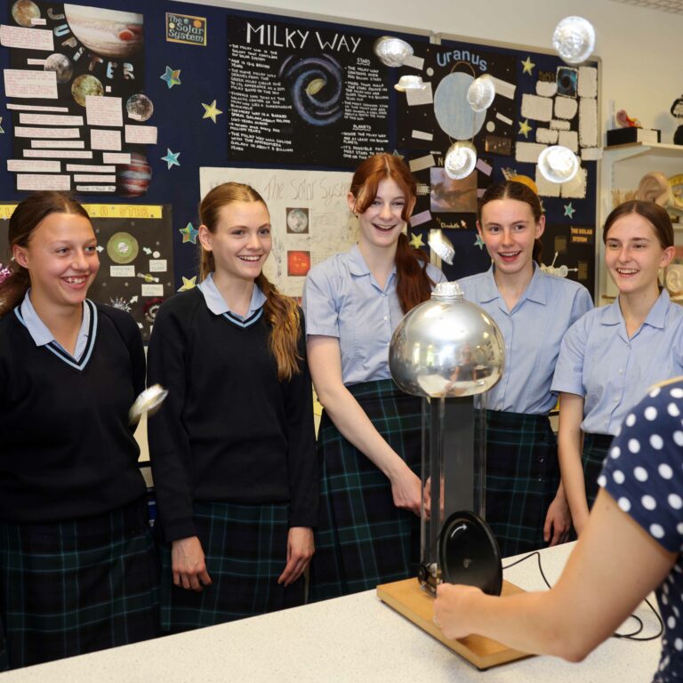 girls watching the display by the teacher