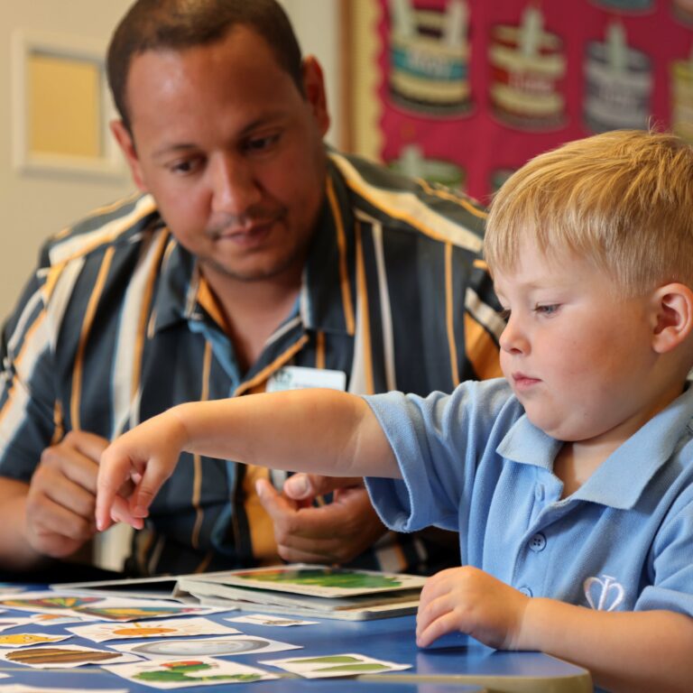 toddler working with his teacher