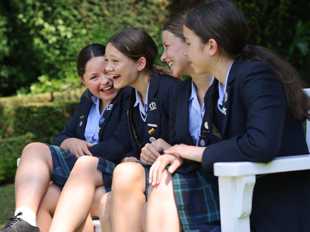 girls sat on a bench