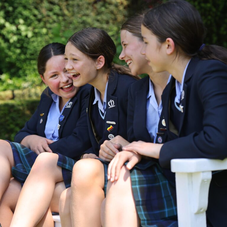 girls sat on a bench